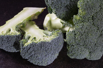Fresh green broccoli florets close up isolated on black background