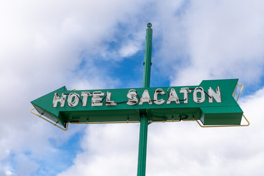 Casa Grande, Arizona - December 23, 2023: Neon sign for Hotel Sacaton against a partly cloudy sky
