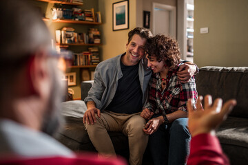 Couple in conversation with a therapist or counselor at home