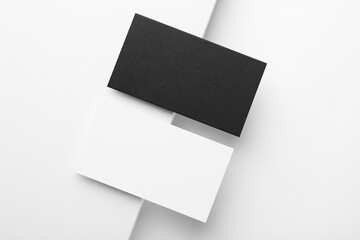 Blank business cards on white background, flat lay. Mockup for design