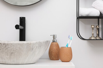 Different bath accessories, personal care products and bathroom vanity indoors