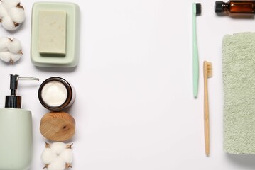 Bath accessories. Different personal care products and cotton flowers on white background, flat lay with space for text