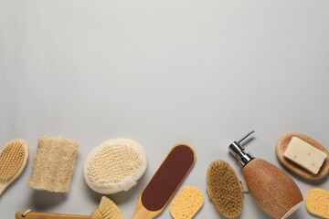 Bath accessories. Flat lay composition with personal care tools on light grey background, space for text