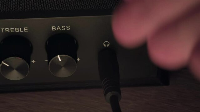 plug the mini jack into the jack, plug the headphones into the speakers, turn up the volume in the speakers, the man turns up the volume