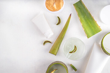  Aloe vera skincare beauty care flat lay. Various bottles, jars set with aloe cream, gel serum with fresh aloe leaves on white background, mockup organic green homemade cosmetics