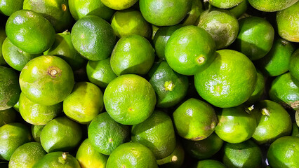 Freshly picked limes in bulk, showcasing their bright green color at a produce market
