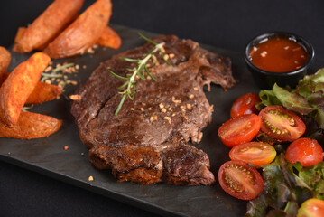 ancho beef steak with rustic roast potatoes and salad with herb dressing