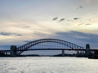 Fototapeta na wymiar Sydney Harbour bridge at night. City harbour bridge silhouette at sunset. Largest steel arch bridge from the ocean at nightfall, Australia.