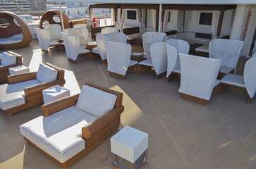 Deck chairs or sun loungers on balcony or terrace or patio pool deck of luxury modern cruise ship...