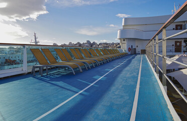 Deck chairs or sun loungers on balcony or terrace or patio pool deck of luxury modern cruise ship...