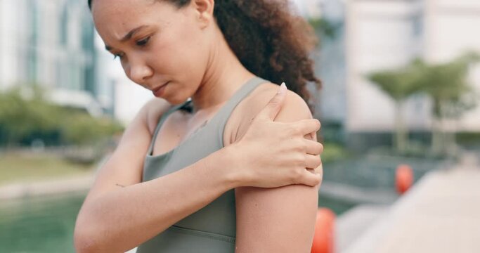Shoulder pain, fitness and woman in a city with workout mistake, risk or anatomy emergency. Arm, injury or female runner outdoor with sports, accident or training, disaster or exercise crisis