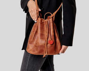 Copper leather bucket bag with motivational slogan for stylish look