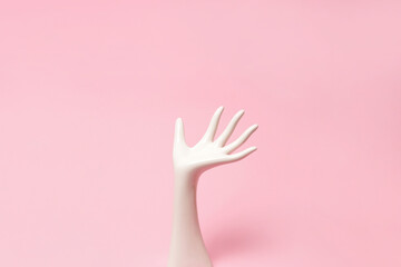 White ceramic statue hand on pink background with copy space - obrazy, fototapety, plakaty