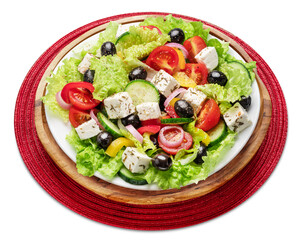 Greek salad on white plate isolated on white background.
