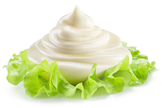 Handful of mayonnaise over lettuce green leaf on white background.