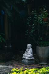 Stone Buddha Statue in a tranquil green garden