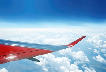 Fototapeta premium Airplane wing on blue sky background. View from airplane window.