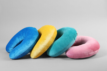 Soft travel pillows on light grey background