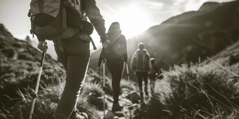 Fotobehang A group of people hiking up a mountain. Suitable for outdoor adventure or travel themes © Fotograf