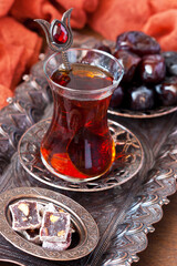 Glass tea  cup with  eastern sweets on  vintage tray