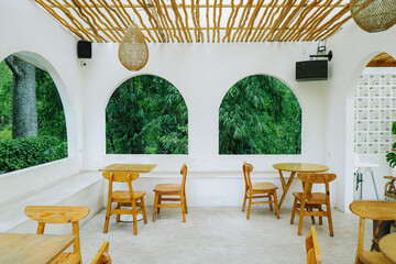 Glassless arched windows with lush greenery view