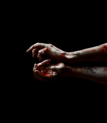 Scary hands of undead with dripping blood over black background