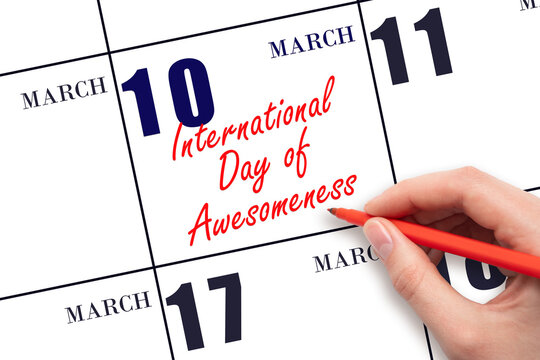 March 10. Hand writing text International Day of Awesomeness on calendar date. Save the date.
