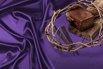 wood cross on a dark fabric background