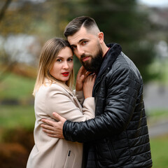 Portrait of a man and a woman in an autumn park.