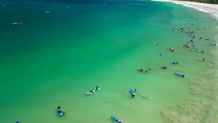 Aerial view of Surfers finding waves in Lombok, Indonesia