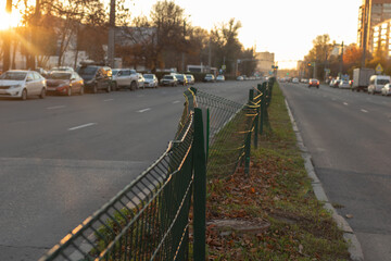Broken fence on the road in the city