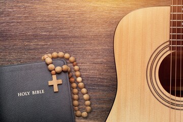 Holy Bible with retro acoustic guitar, music concept