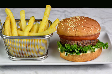  veggie burger on a sesame bun  with frie