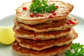 Top view of a plate of corn fritters.Perkedel Jagung or Bakwan Jagung. Corn fritters is Indonesian traditional food. Savory snack made of corn, flour, spring onion, and salt. Vegetarian food,Thai food