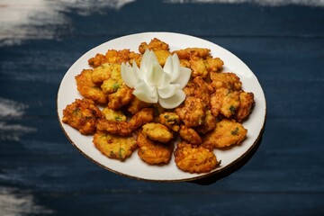 Corn Fritters with Corn. Healthy and Diet Food . Crispy fried corn ball in a white plate on wooden table, Vegetarian food, Thai food, snacks Thai style. Zucchini fritters or vegetarian zucchini pancak