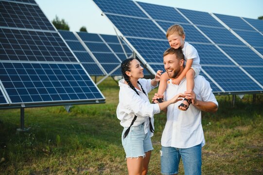 Happy family near solar panels. Alternative energy source