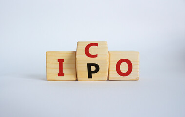 ICO and IPO symbol. Wooden cubes with words ICO - initial coin offering and IPO - initial public offering. Beautiful white background. Business concept. Copy space