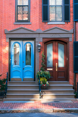 vintage neighbour entrance doors to the house, front red brick wall building street view, american expensive district