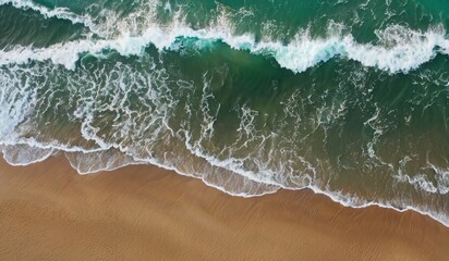 aerial view of ocean wave hitting the beach