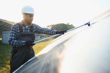 Indian worker cleaning solar panels