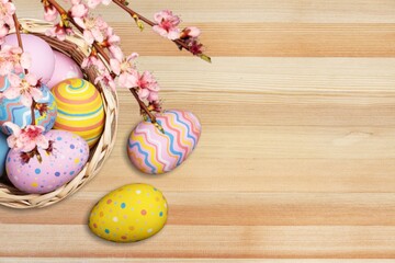 Fototapeta na wymiar Composition with colored Easter eggs on wood background