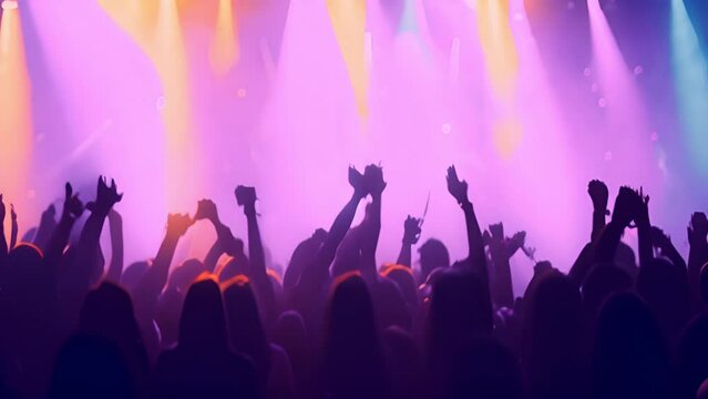 Rear back view of audience crowd people fans raising hands enjoying live music festival concert event rock band silhouettes performance sing on night club outdoor stage. 4k video blurred effect with c