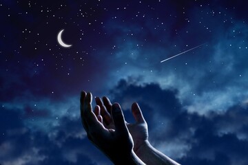 Pray hands open to the blue night sky