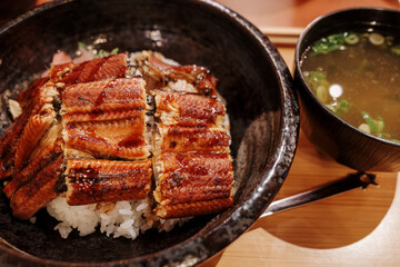 Unagi Don, Japanese grilled eel with teriyaki sauce serve with rice and Miso soup, on the counter...