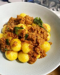 small round gnocchi, round Silesian dumplings, meat sauce, basil, flour dish