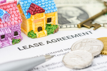Business legal document concept : Pen, coins, key on a lease agreement form. Lease agreement is a contract between a lessor and a lessee that allow lessee rights to use of a property owned by lessor. - obrazy, fototapety, plakaty