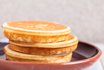 Golden pancakes in close-up on a gray background - 734212897