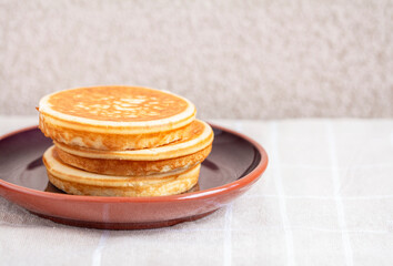 Golden pancakes in close-up on a gray background - 734213498