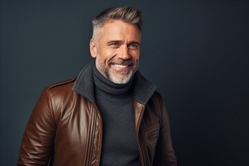 Portrait of a handsome mature man in a leather jacket and scarf. Men's beauty, fashion.