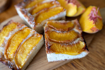 peach tart and fresh fruit closeup on wooden background horizontal view from above